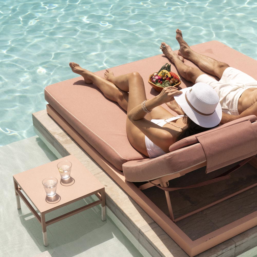 Couple reclining poolside at the Alizée Pool & Beach Club